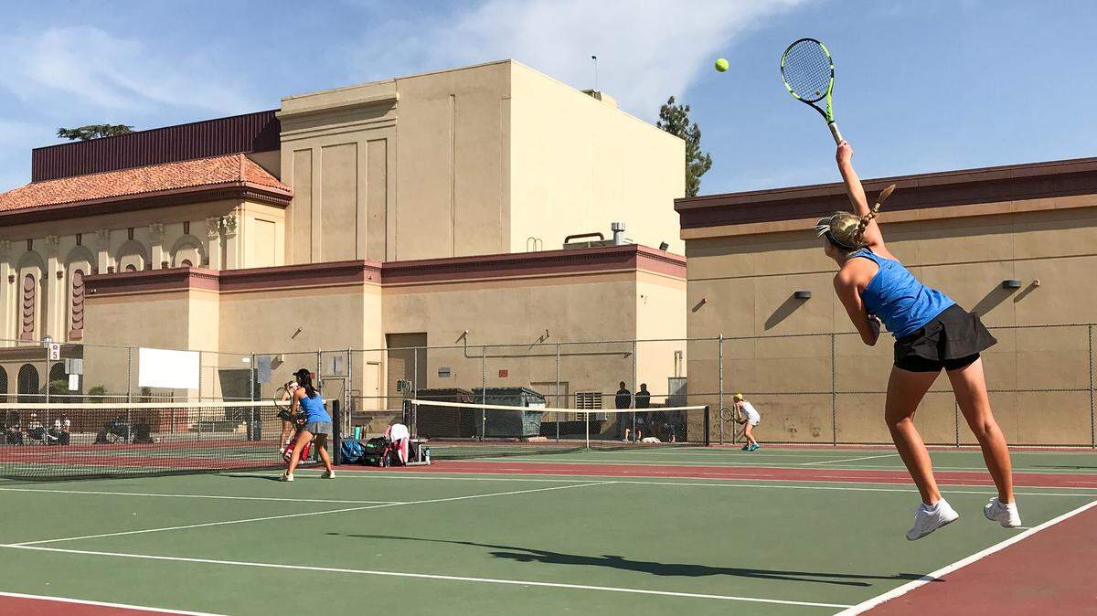 Clovis North’s Jordann Pickett serves during the Central Section girls tennis doubles championship match Saturday afternoon, Nov. 3 at Redwood High in Visalia.