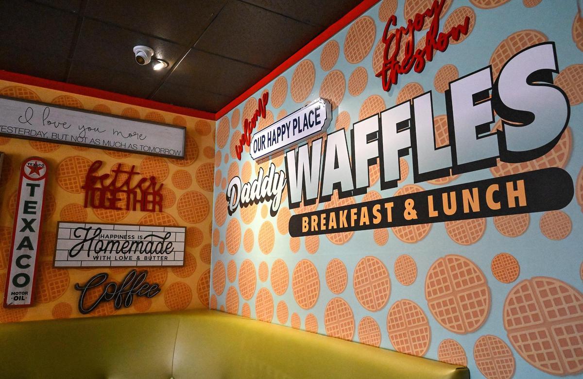 Signs adorn the waffle wallpaper decor at Daddy Waffles opening in the shopping center northwest of Herndon and Marks in Fresno.
