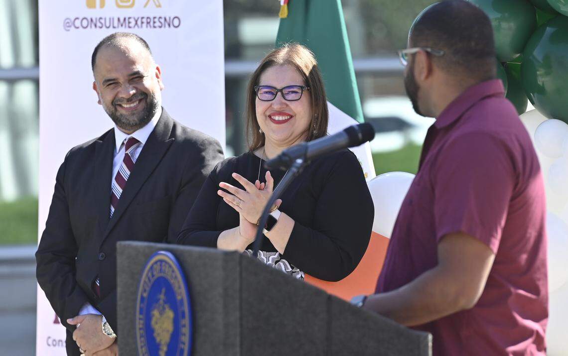 The new Mexican Consul Irma de Los Ángeles Pimentel Portilla, center, claps after Fresno City councilperson Nelson Esparza, right, spoke at a Mexican flag-raising ceremony outside Fresno City Hall Tuesday, Sept. 16, 2025 in downtown Fresno.