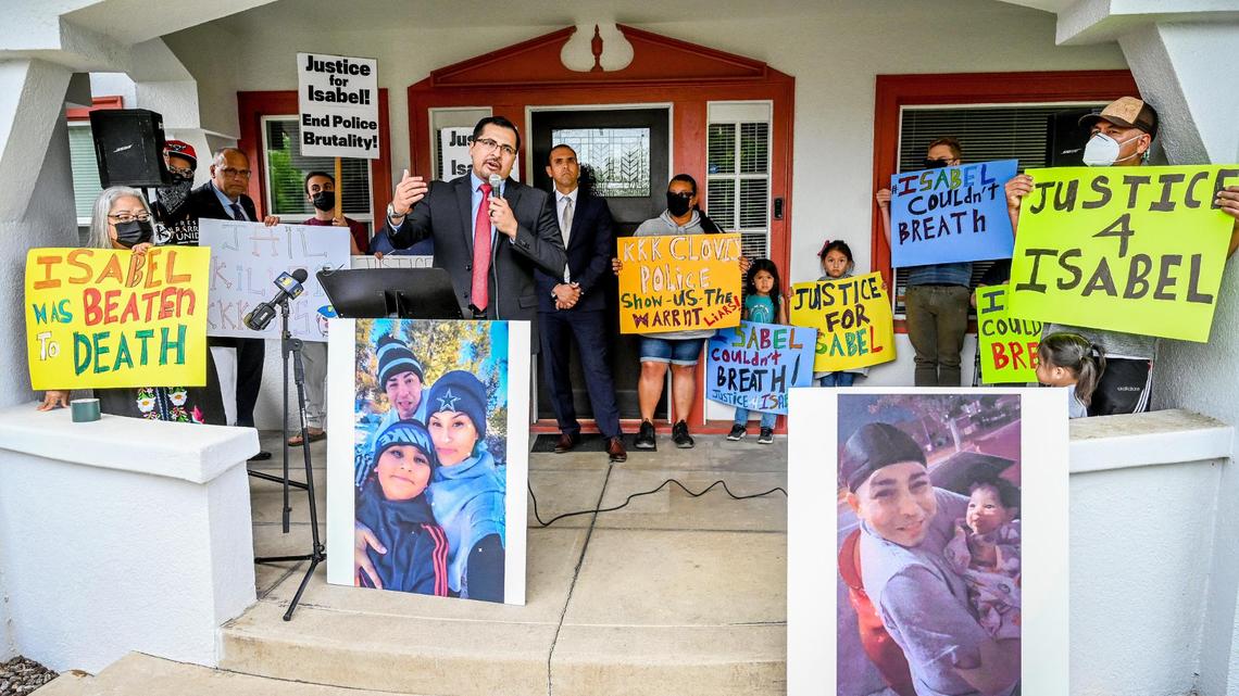 Attorney Edgar Flores of the Gonzalez & Flores Law Firm of Nevada is surrounded by supporters of Isabel De La Torre while holding a news conference to announce a lawsuit filed against the Clovis Police Department in the death of De La Torre earlier this year, outside the law office of attorney Kevin Little in Fresno on Friday, June 17, 2022.