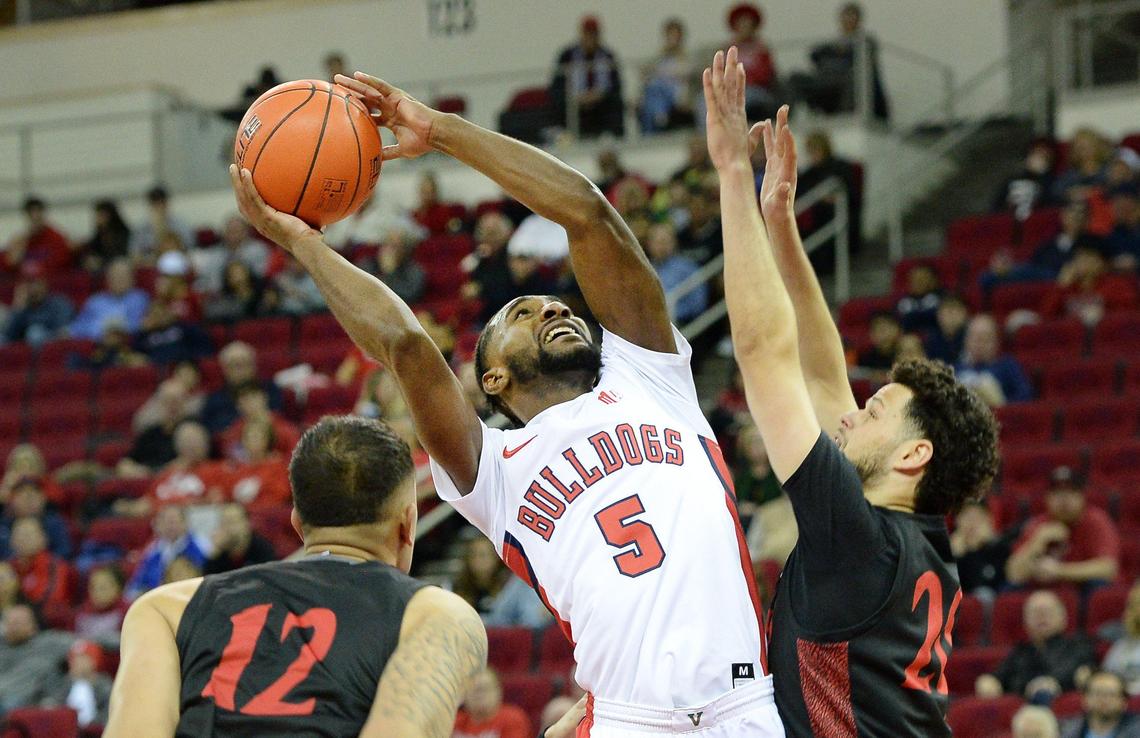 Fresno State guard Jordan Campbell, center, tries to get a shot up between San Diego State’s Nolan Narain, left, and Jordan Schakel during the Bulldogs’ 64-55 loss at the Save Mart Center in Fresno on Tuesday, Jan. 14, 2020.
