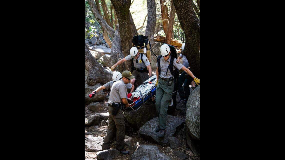 Rescue personnel transport a patient on a litter from Lower Yosemite Fall boulder field.