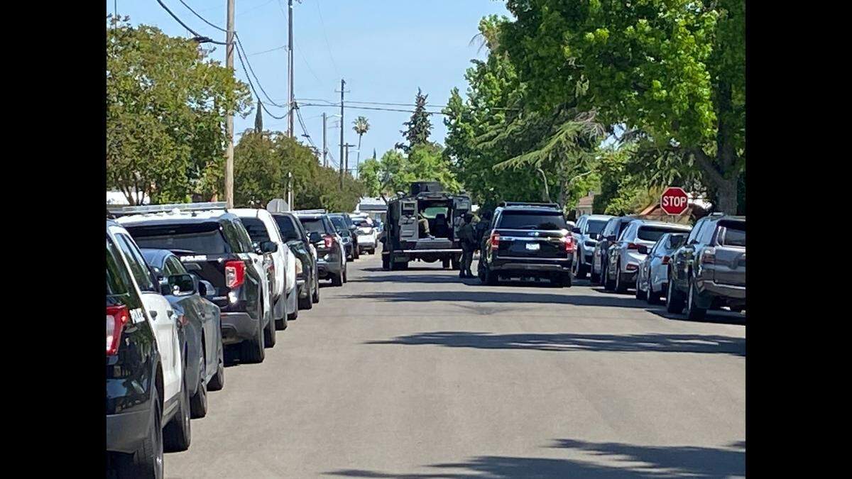 Police and SWAT set up a perimeter in a neighborhood northwest of Dakota and Cedar avenues Friday, May 12, 2023, after a man suspected of three shootings fled from officers, police said.