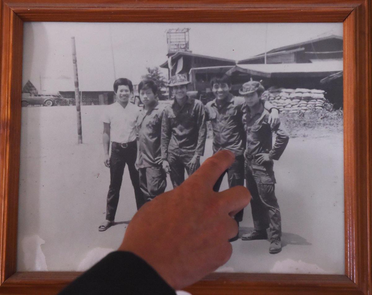 Chongge Vang, 79, a lieutenant in the CIA-backed Secret War, points to a photo with his friends during the Secret War. Photographed at Vang’s home Wednesday, July 24, 2019 near Sanger.