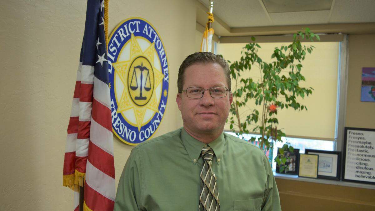 The man dead in a solo vehicle crash in northeast Fresno Tuesday morning was identified as 49-year-old Michael Rossi, a Fresno County District Attorney investigator.