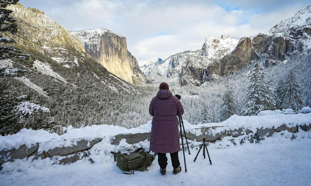 Arwin Levinson of Las Vegas makes pictures of Yosemite Valley at Tunnel View in Yosemite on Wednesday, Dec. 15, 2021, following a snowstorm the day before.