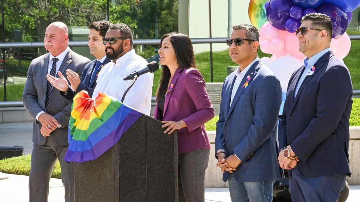 Fresno City Councilmember Annalisa Perea, at lectern, speaks during the 3rd Annual Pride Flag Raising Ceremony at Fresno City Hall on Friday, June 9, 2023, as her fellow councilmembers and Mayor Jerry Dyer stand at her side.