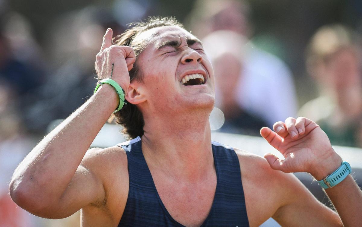Ben Olney of Yosemite High celebrates winning the Central Section boys Division V cross country race at Woodward Park in Fresno on Thursday, Nov. 17, 2022.