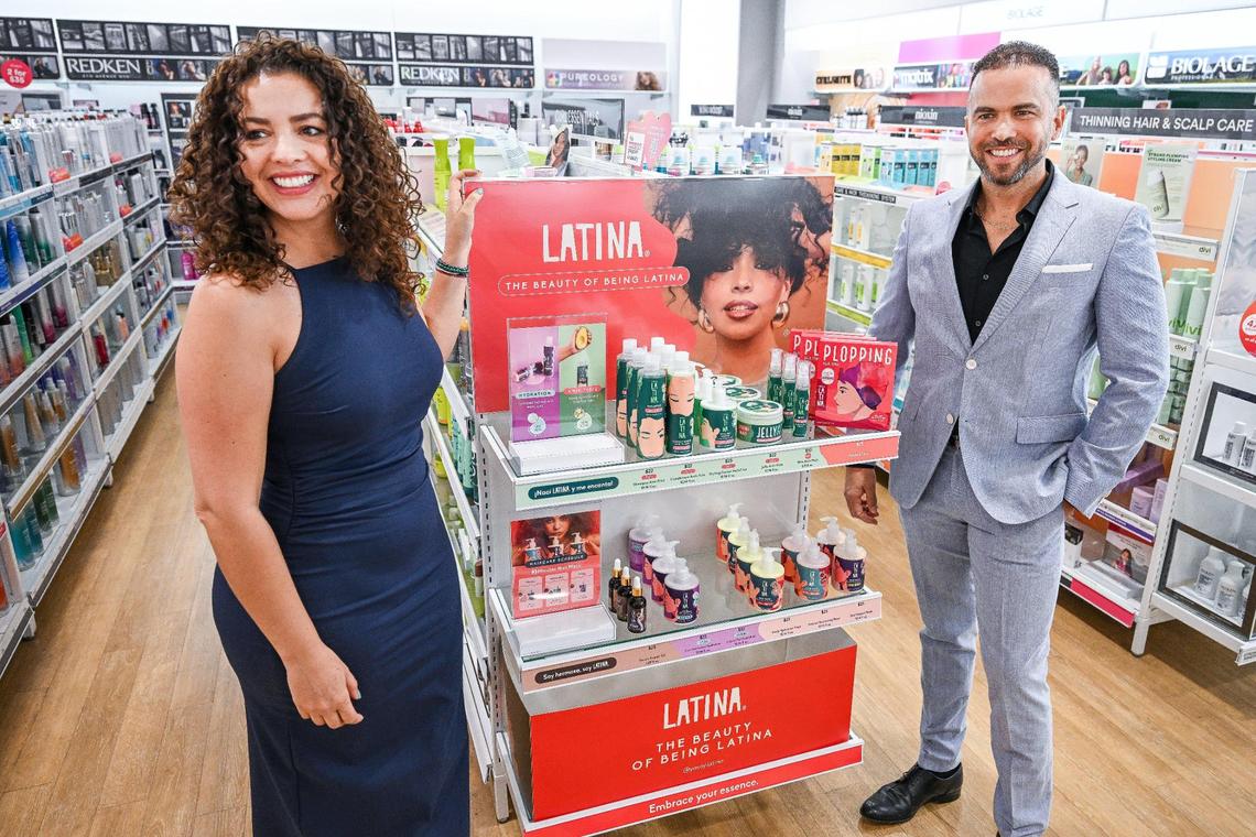Pilar García Bonilla stands with her brother and business partner Victor García Bonilla in front of their new product line of haircare products called Latina before officially launching the line in the U.S. at Ulta Beauty in Fresno on Friday, April 25, 2025.