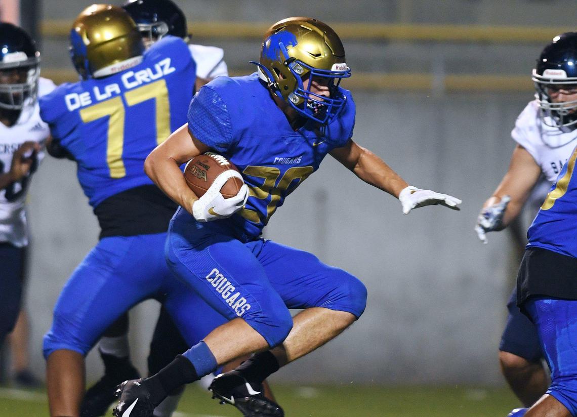 Clovis High’s Tristan Risley runs up the middle against Bakerfield Friday, Aug. 27, 2021 in Clovis.