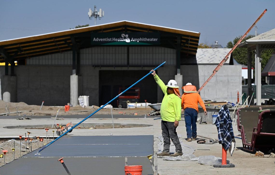 Workers float the concrete at the new Adventist Health Amphitheater, which promises to bring music and food trucks and other events to central Tulare. Photographed Friday, Oct. 18, 2024.