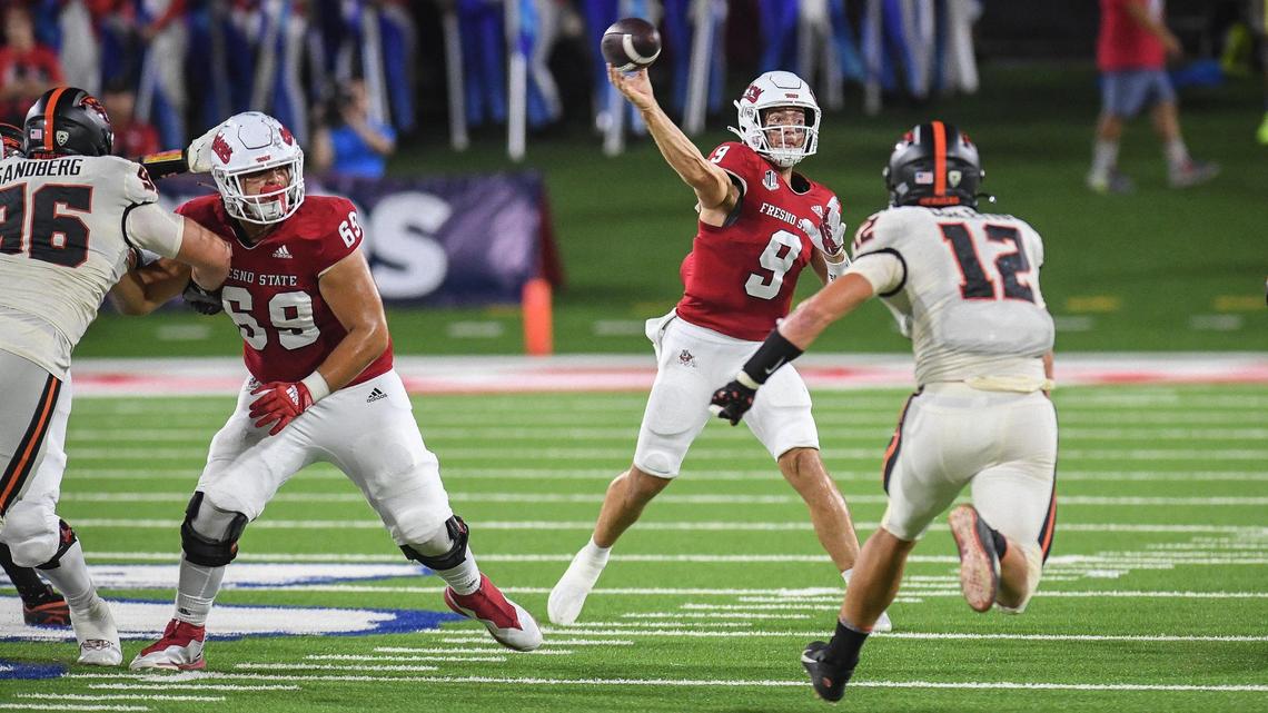 Fresno State quarterback Jake Haener throws past Oregon State linebacker Jack Colletto in the first half of their game at Valley Children’s Stadium in Fresno on Saturday, Sept. 10, 2022.