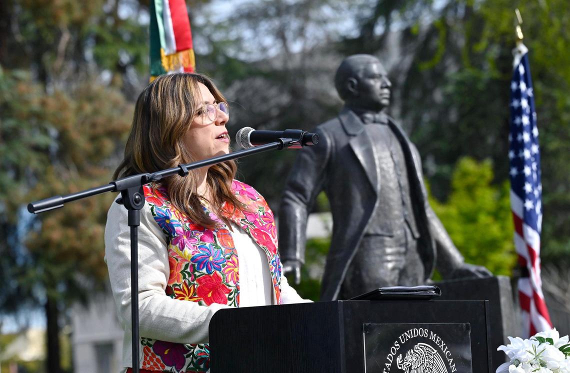 Head Consul of Mexico Nuria P. Zúñiga Alaniz leads an event marking the 219th nnniversary of the birth of Benito Juarez, with the statue of Juarez in the background in Fresno’s Courthouse Park, Friday morning, March 21, 2025 in downtown Fresno.