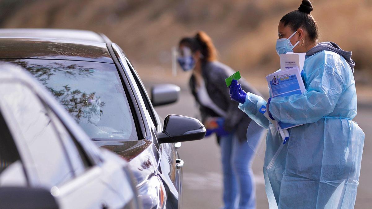 Health care workers offer COVID-19 testing at Cristo Rey Church Friday afternoon, Nov. 20, 2020 in Malaga, south of Fresno.