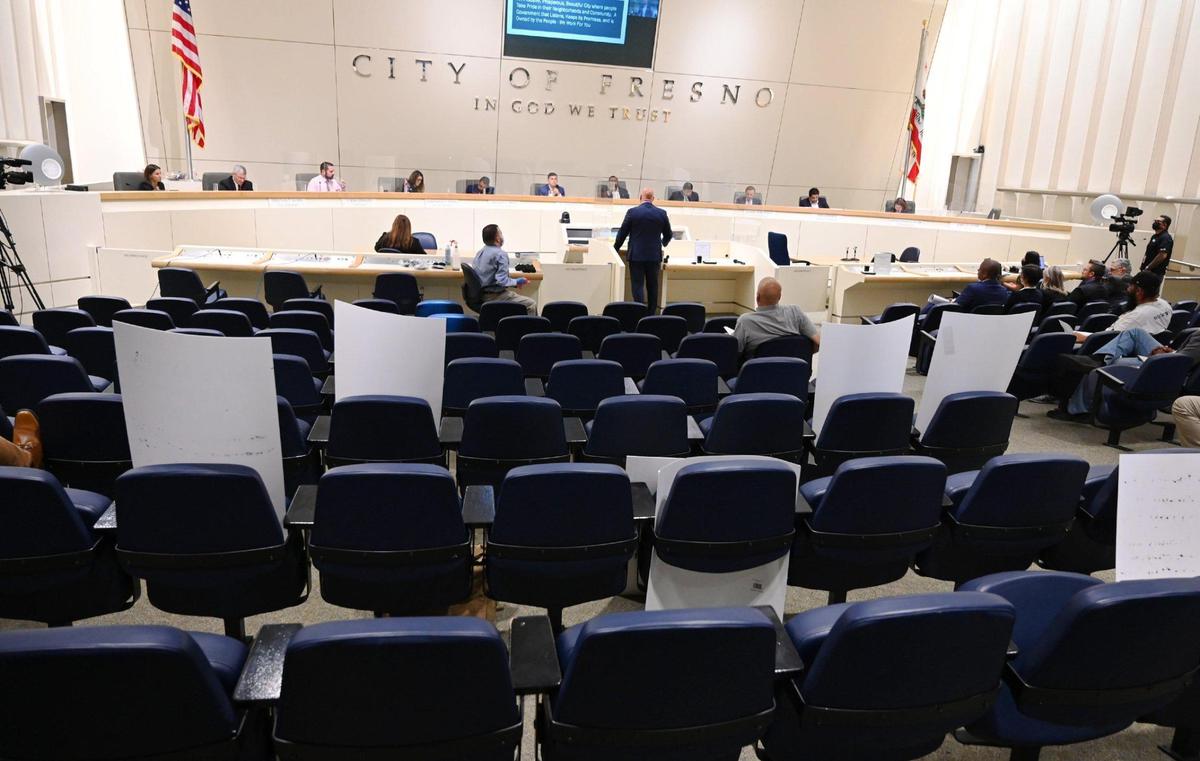 People who favored the “Here to Stay” report over Fresno Mayor Jerry Dyer’s “One Fresno Housing Strategy” walked out but left their placards in their seats as the mayor addressed the city council during a special meeting for presentations about housing plans in answer to the housing crises Wednesday, April 27, 2022 in Fresno.