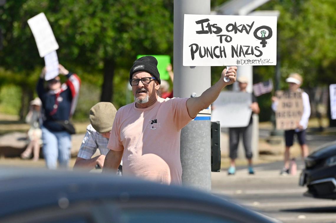 Nick McCoy of Clovis stands on the median as an estimated 400 plus of all ages gathered at the corner of Shaw and Clovis avenues for a Hands Off rally Saturday, April 19, 2025 in Clovis.