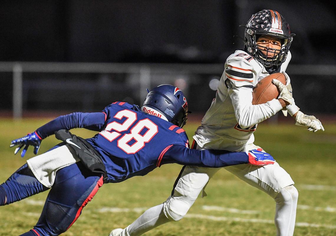 Memorial’s Logan Dasilva attempt to tackle Central’s David Bell on a kickoff return in their Division I playoff game at San Joaquin Memorial on Thursday, Nov. 10, 2022.