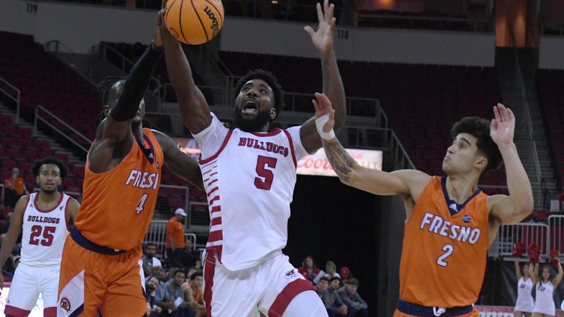 Fresno State guard Jordan Campbell drives between Fresno Pacific’s Michael Mensah, left, and Isaac Peralta, right, Monday, Nov. 7, 2022 in Fresno. The Bulldogs beat the Sunbirds 69-56.