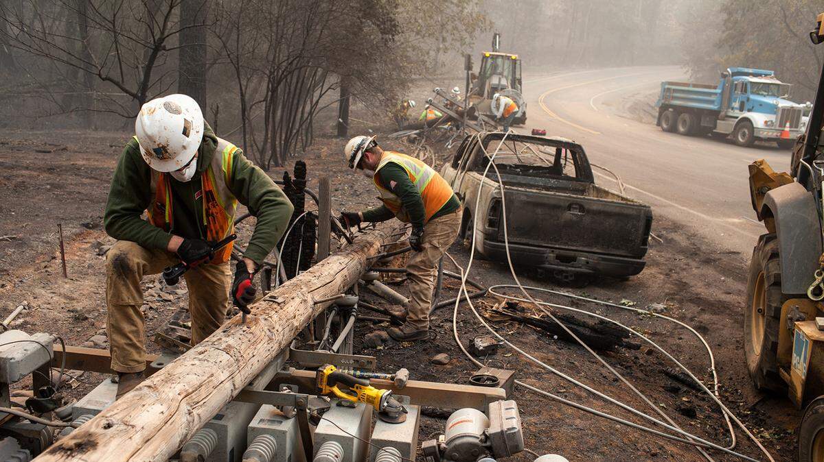 PG&E workers dissemble broken power lines after the Camp Fire ripped through Paradise on Nov. 15, 2018. A faulty transmission line owned by the utility company was the cause of the devastating fire, which killed 85 people.