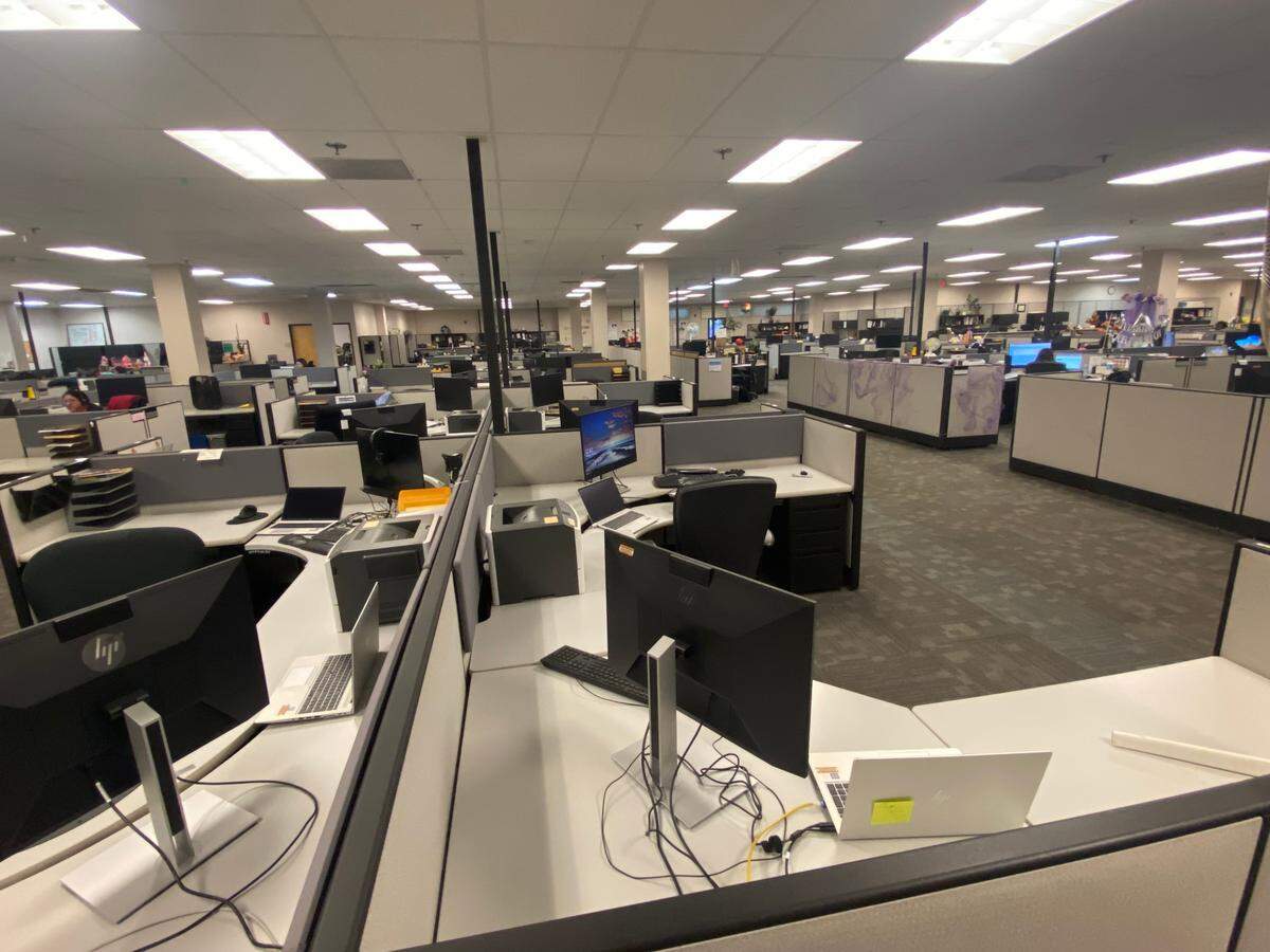DMV employees answer calls in the call center in Manchester Mall in Fresno on Tuesday.