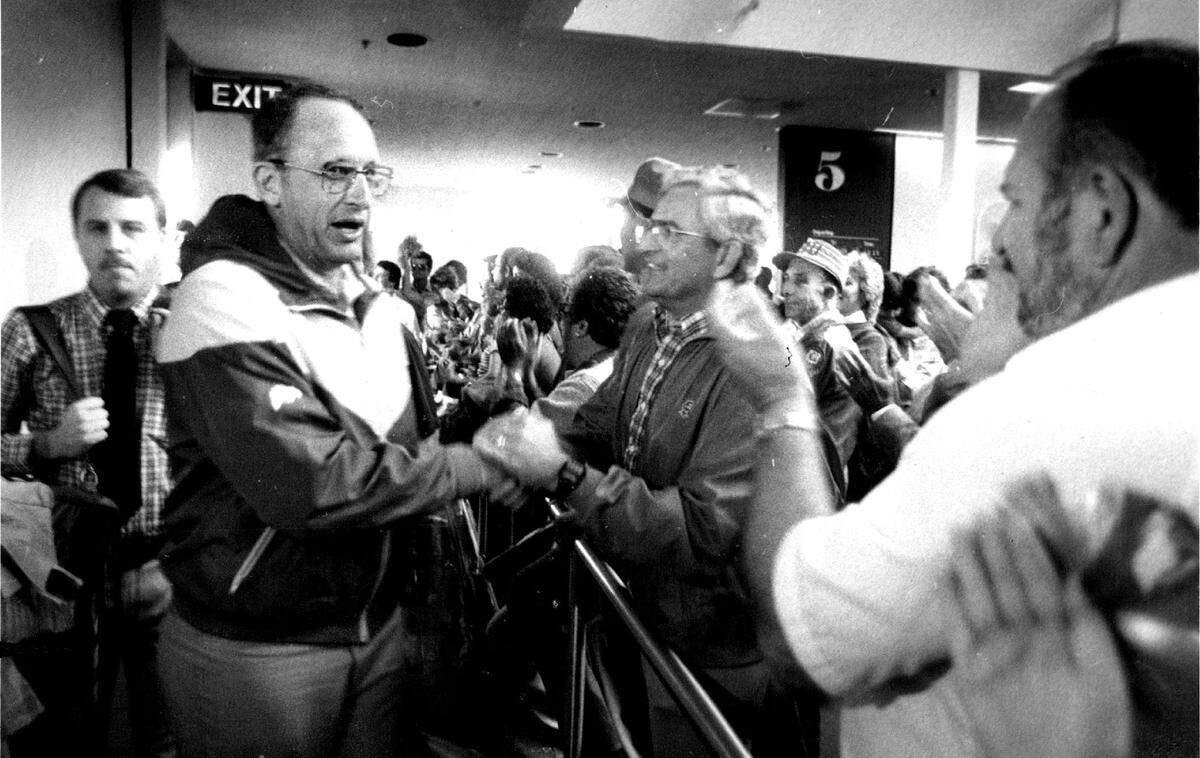The Red Wave greets Fresno State basketball coach Boyd Grant  as he and his team return from an NCAA regional loss to Louisiana Tech and Karl Malone in Memphis.