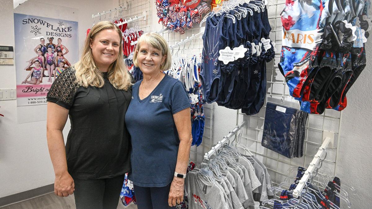 Kindra Snow-Walker, left, and LaDonna Snow, the mother and daughter owners of Snowflake Designs in Clovis stands with some of their Paris Olympics-themed gymnastics wear in their showroom on Friday, July 26, 2024.