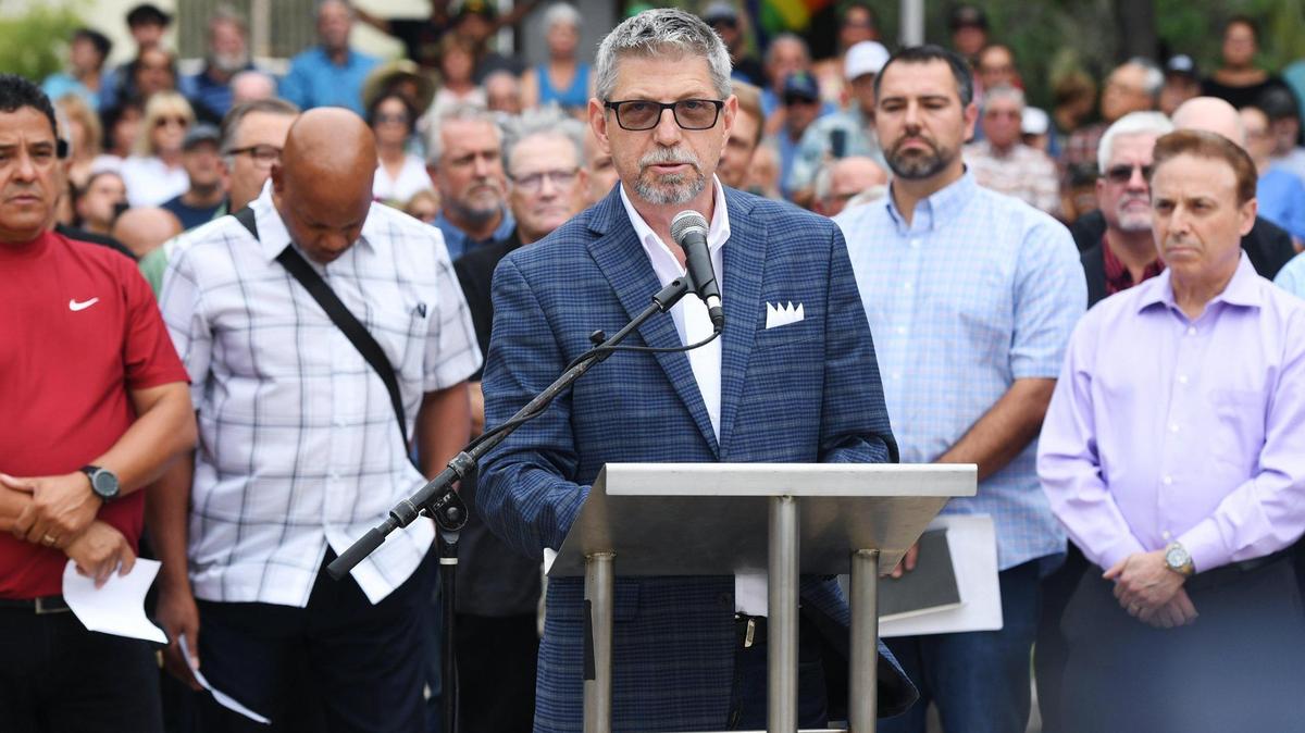 Pastor Jim Franklin, center, addresses the media backed by local clergy and supporters in the far background as Cornerstone Church, Adventure Church and others hold a press conference at Eaton Plaza against the recent Pride flag raising at Fresno City Hall Wednesday, June 22, 2022 in Fresno.