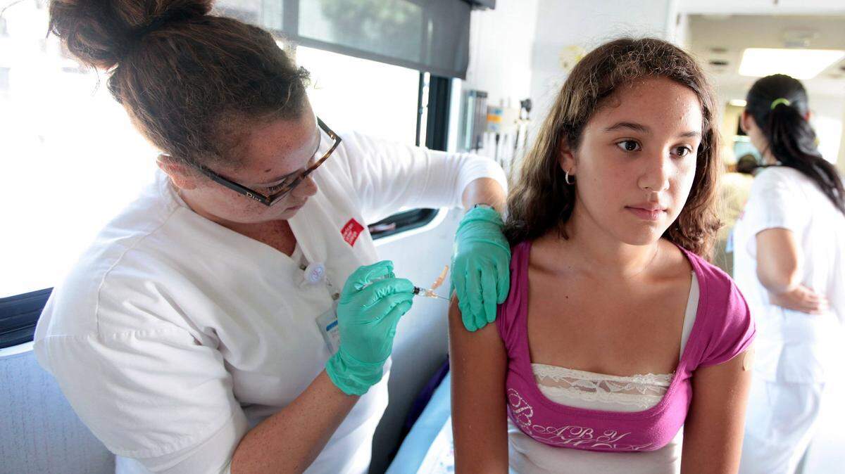 Twelve-year-old student Cecilia Almeida receives free childhood immunizations during the annual Back to School Health Fair at St. Francis Medical Center in Southern California.