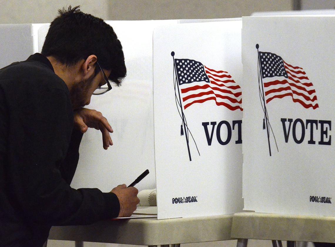 A voter ponders his ballot at the Clovis Veterans Memorial District Hall on Tuesday morning, Nov. 6, 2018.
