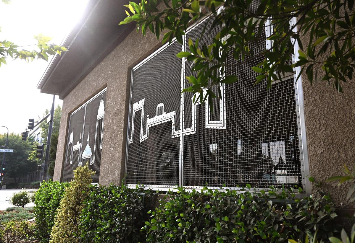 Metal grating along Cosmopolitan Tavern & Italian Grill’s patio features a skyline of Fresno, photographed Friday, Oct. 25, 2024.