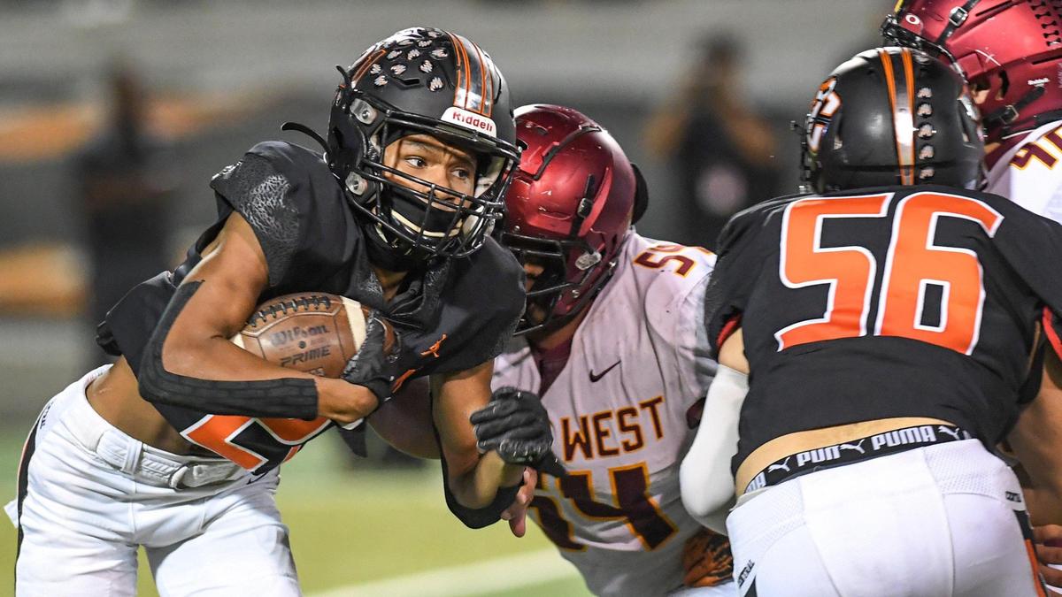 Central’s David Bell runs the ball against the Clovis West defense during their football game at Deran Koligian Stadium on Friday, Oct. 21, 2022.