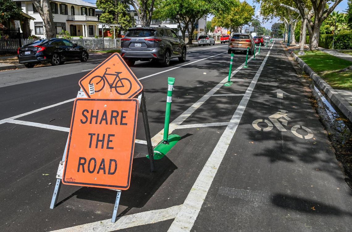 A cycling road sign stands next to a new bike lane located on Van Ness Avenue near Olive Avenue on Tuesday, Sept. 20, 2022. Although a few markings and signs denote the changes, motorists have been parking in the bike lanes mostly due to confusion about the new layout meant to protect cyclists.