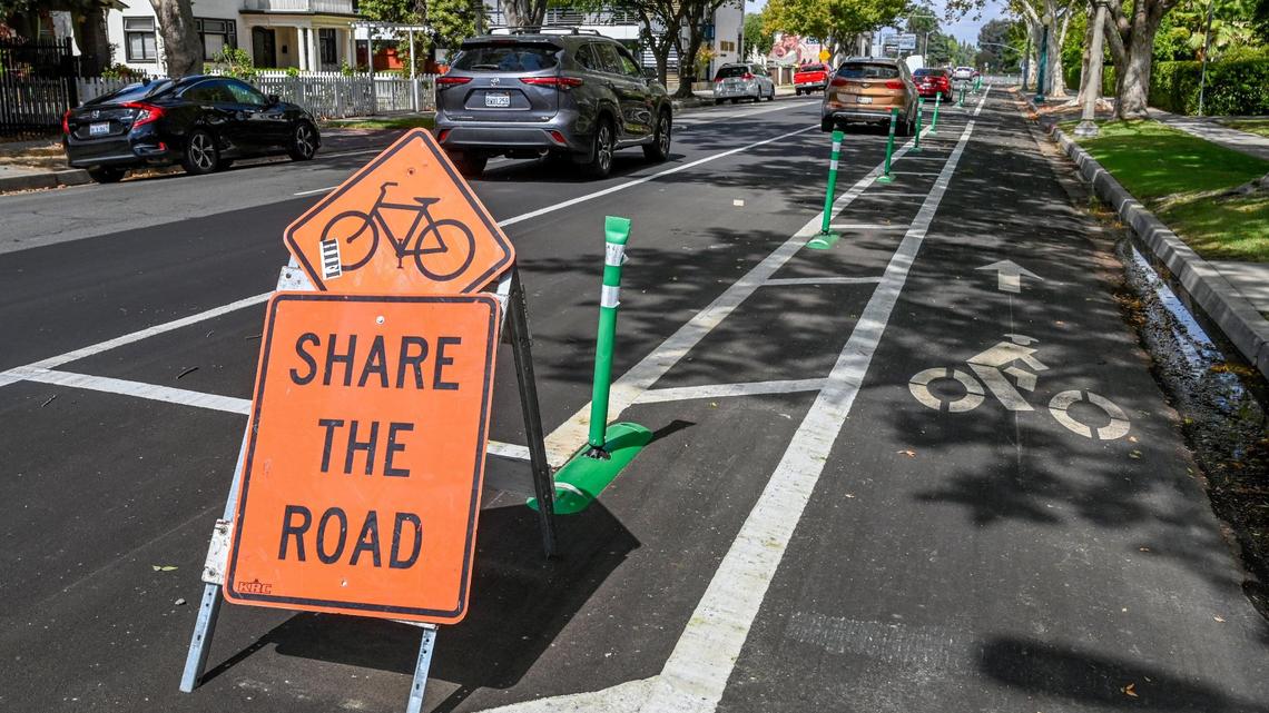 A cycling road sign stands next to a new bike lane located on Van Ness Avenue near Olive Avenue on Tuesday, Sept. 20, 2022. Although a few markings and signs denote the changes, motorists have been parking in the bike lanes mostly due to confusion about the new layout meant to protect cyclists.