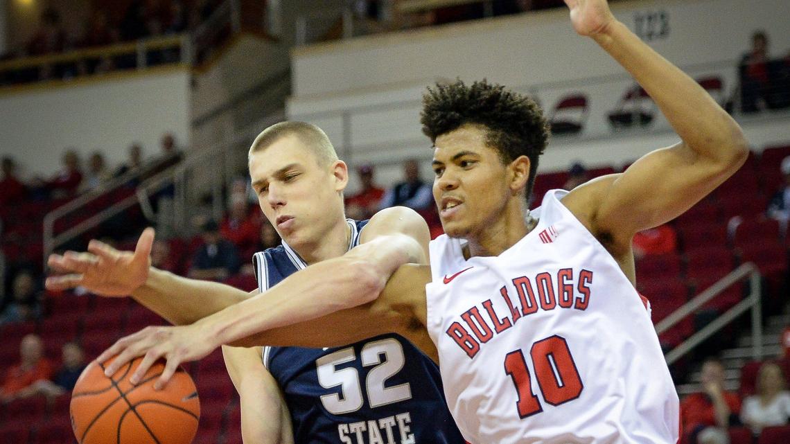 Fresno State freshman Orlando Robinson, right, fouls Utah State’s Kuba Karwowski while going for the ball during their game at the Save Mart Center in Fresno on Saturday, Feb. 15, 2020.