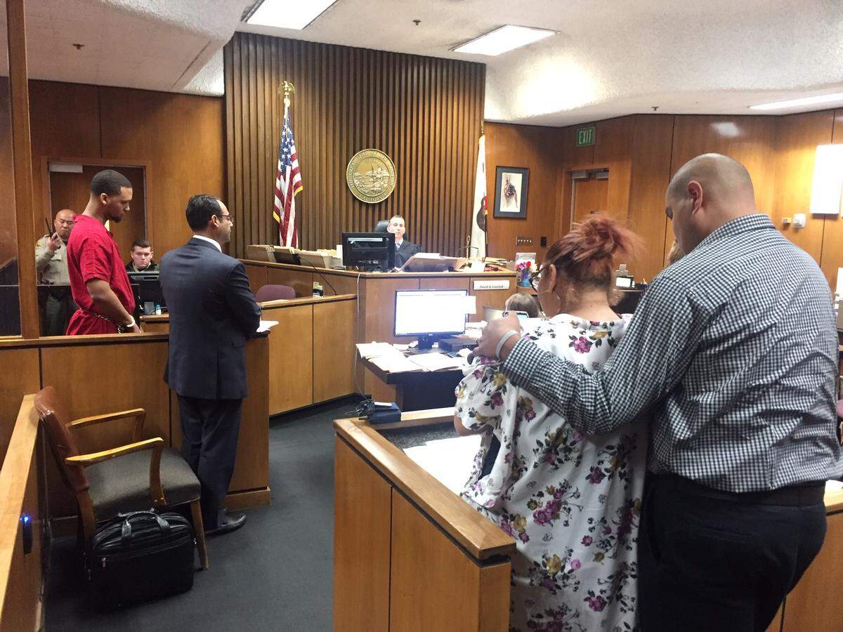 Inmate Michael Merritt-Hutchins, left in red jumpsuit, stands as Sarah Casas, standing at a podium, reads a statement to the judge in Fresno County Superior Court. The defendant received eight years in prison for gross vehicular manslaughter while intoxicated that killed two people.
