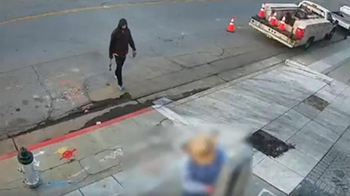 Video frame grab shows a suspect identified as 30-year-old Dyllan Hopkins (aka Dyllan Padavona) approaching city public works employee Timothy Smith in the moments before police said Hopkins attacked Smith with a blunt object at Kern and G Streets in downtown Fresno on April 11, 2025.