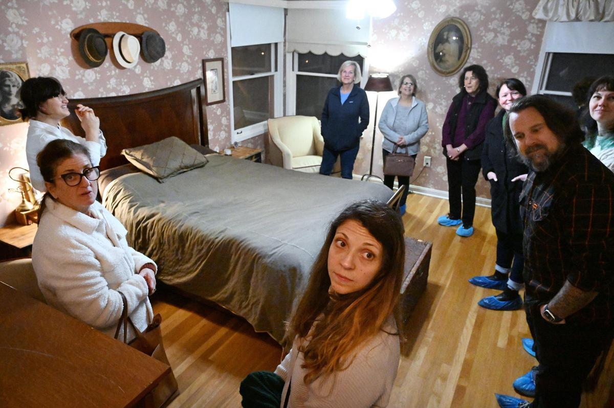A bedroom with original floral wallpaper is viewed during the 2024 Fresno High Neighborhood Holiday Home Tour Monday evening, Dec. 2, 2024.