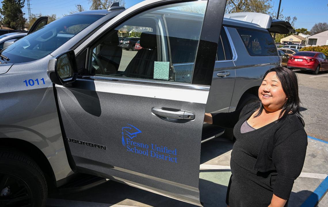 Fort Miller Middle School Community School coordinator Xee Xiong shows the program’s Chevrolet Suburban vehicle, which gives the school flexibility in transporting teachers and students for various activities, while at the Fresno school on Friday, March 8, 2024.