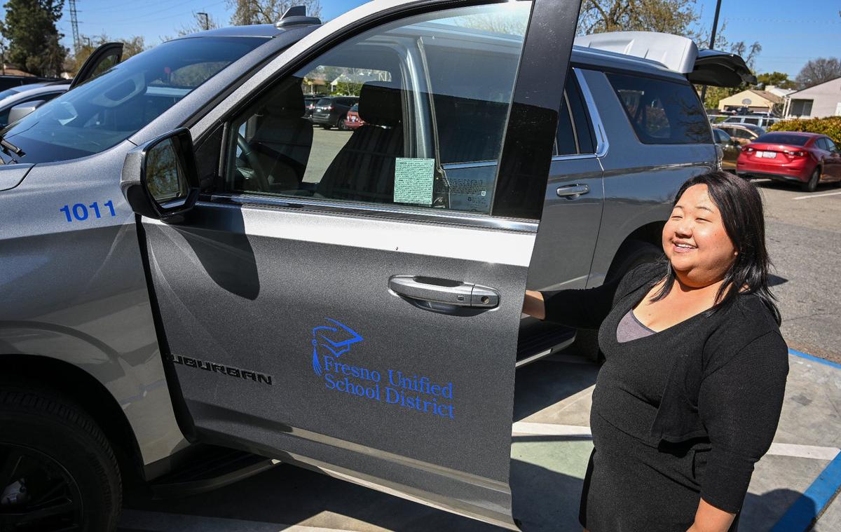 El coordinador de la Escuela Comunitaria de Fort Miller Middle School, Xee Xiong, muestra el vehículo Chevrolet Suburban del programa, que proporciona a la escuela flexibilidad para el transporte de maestros y alumnos a diversas actividades, mientras se encuentra en la escuela de Fresno, el viernes 8 de marzo de 2024.