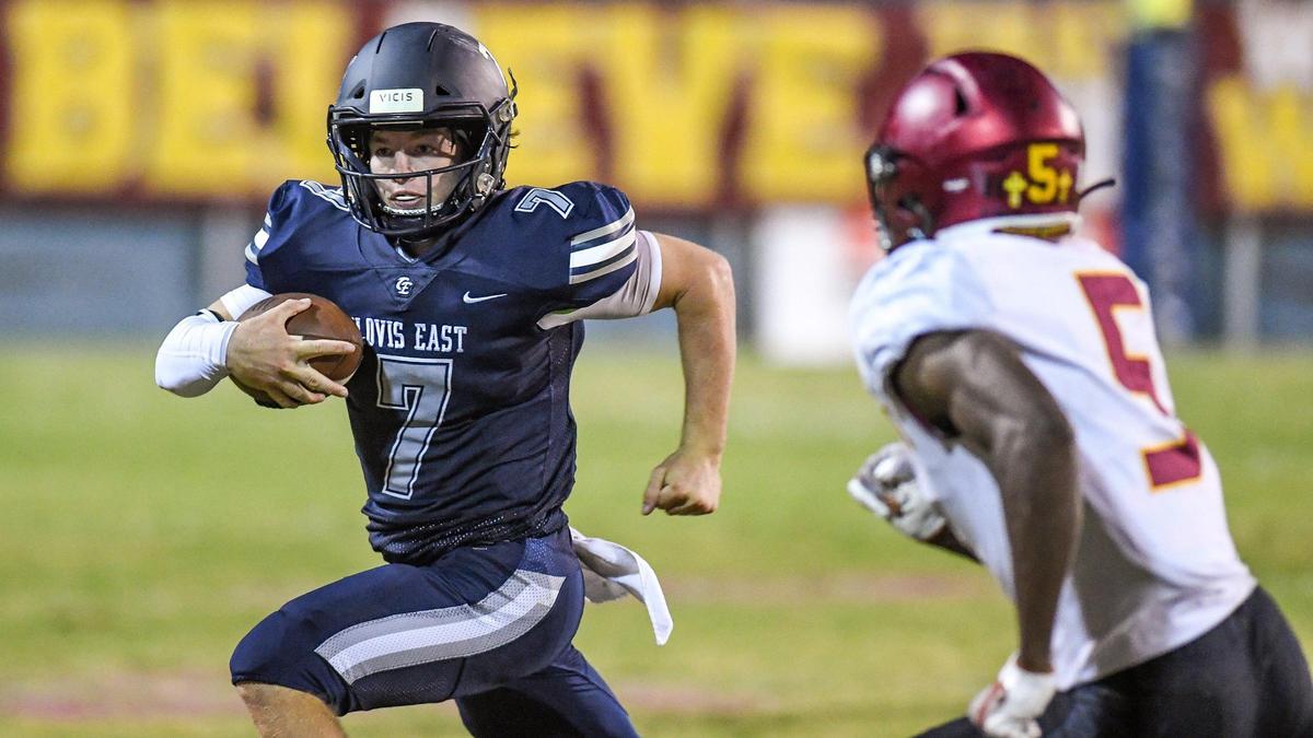 Clovis East quarterback Tyus Miller dashes for a few yards before being knocked out of bounds by Clovis West’s Marshel Sanders during their game at Lamonica Stadium on Friday, Oct. 7, 2022.
