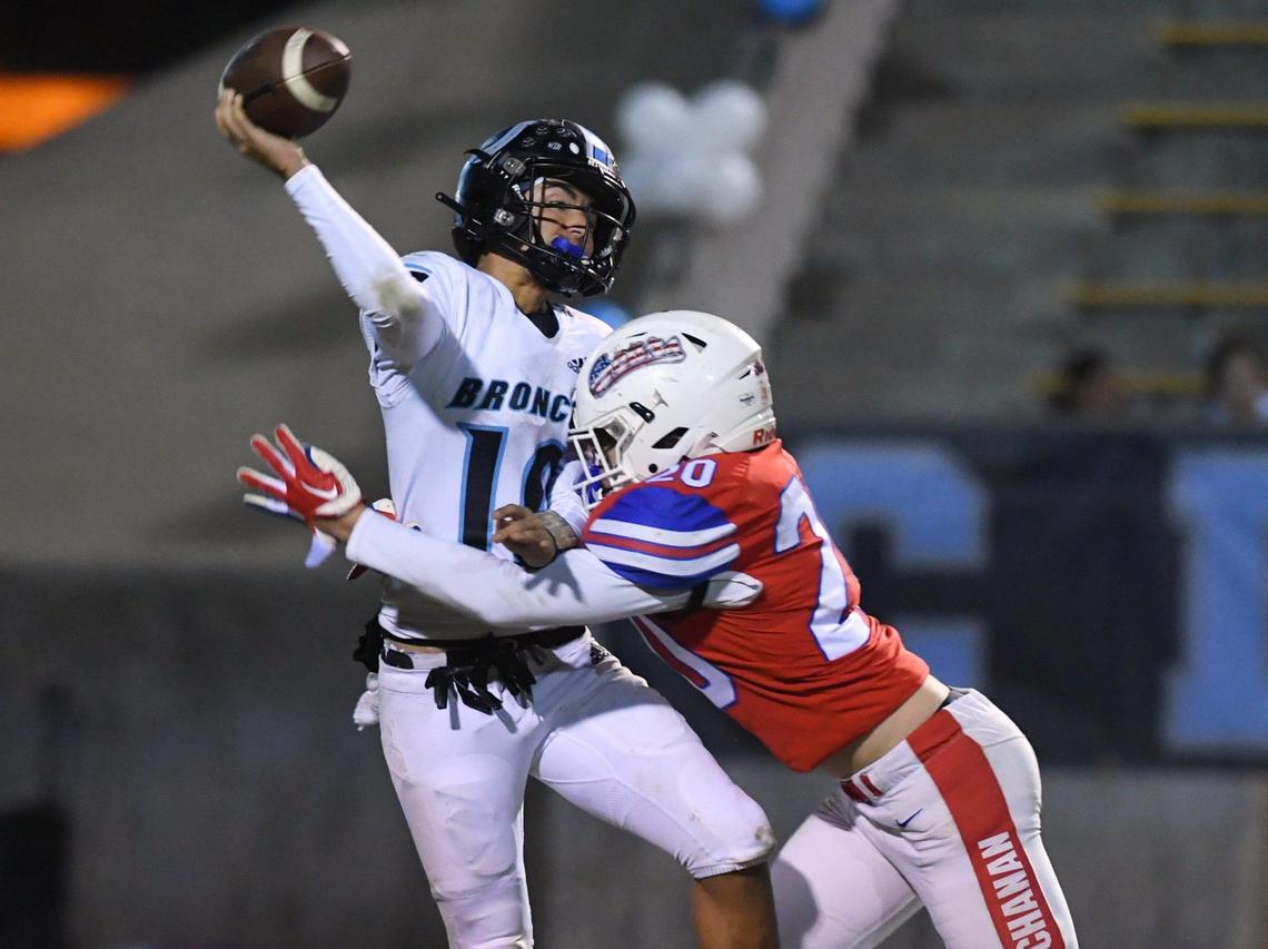 Buchanan’s Joshua Wilson, right, hits Clovis North quarterback Mario Cosma as he throws in a Central Section Division I quarterfinal on Thursday, Nov. 10, 2022 in Clovis.
