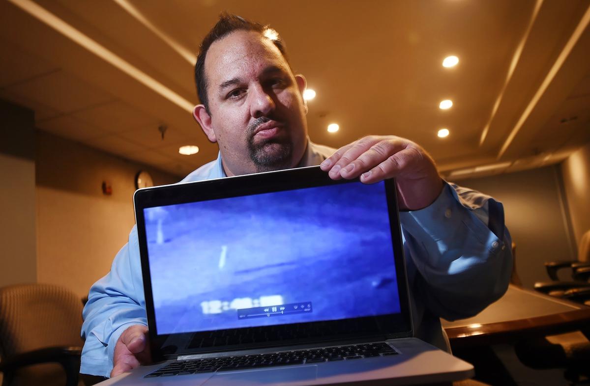 Michael Banti of Weird Fresno poses with a laptop displaying surveillance video captured by a Fresno homeowner years ago as Banti talks about the Fresno Nightcrawler in an interview in October 2018.
