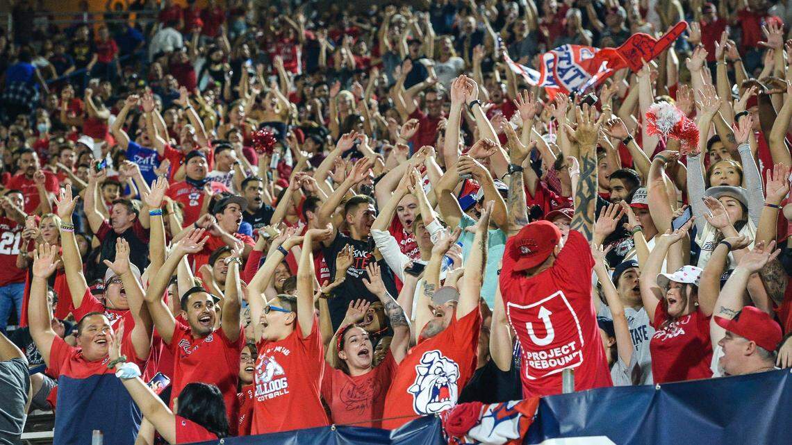 Fans in the Fresno State student section do the wave during the Bulldogs’ game against UNLV at Bulldog Stadium on Friday, Sept. 24, 2021.