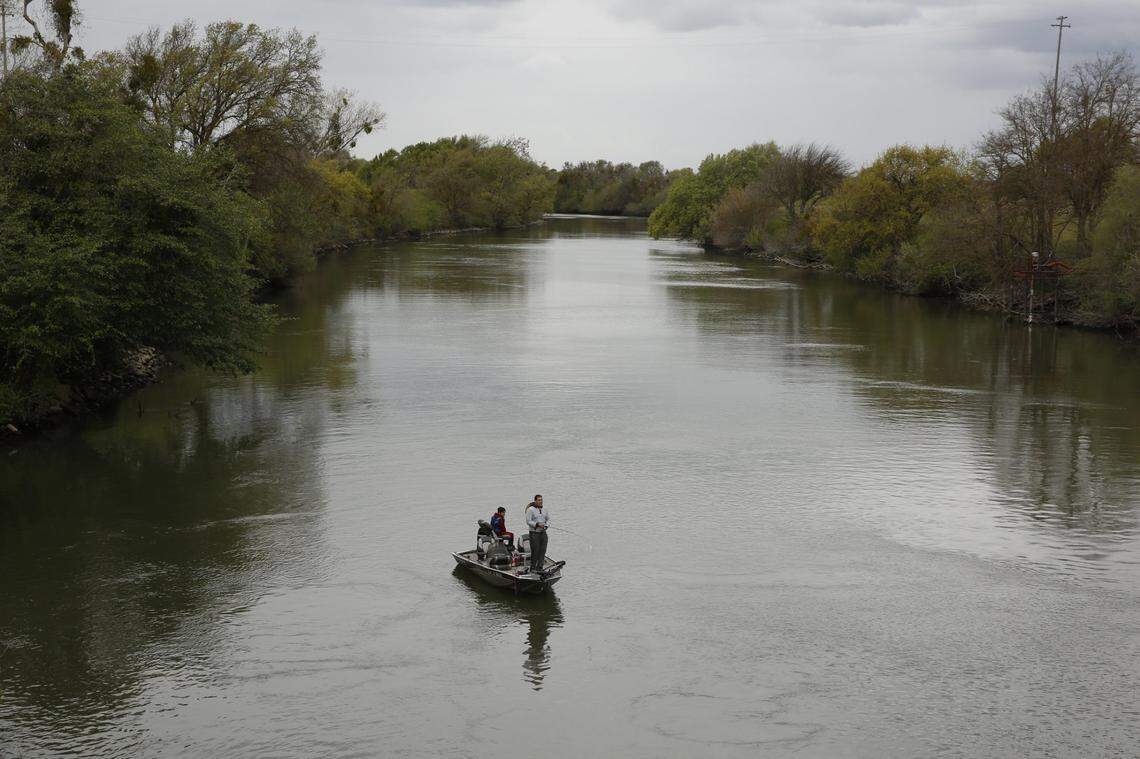 People fish in the Sacramento-San Joaquin River Delta’s Elk Slough near Courtland in this 2020 photo.