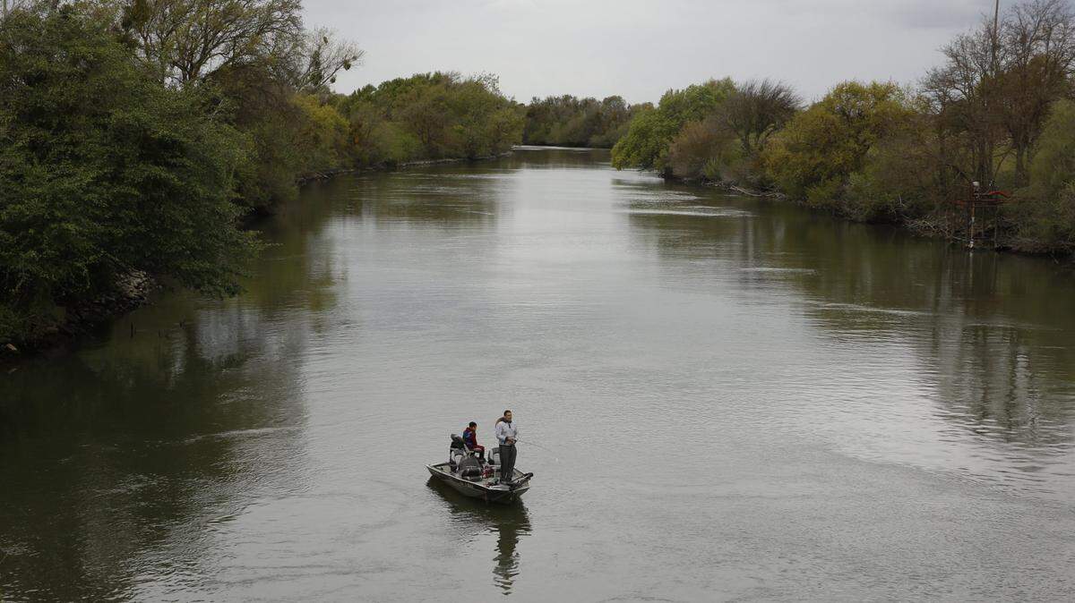 People fish in the Sacramento-San Joaquin River Delta’s Elk Slough near Courtland in this 2020 photo.