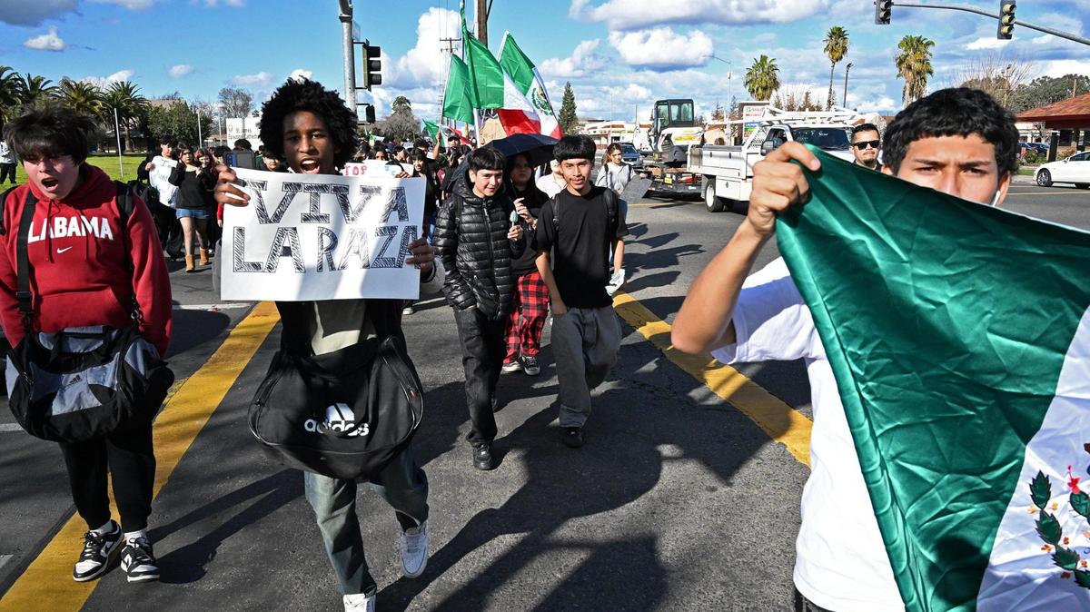 Students from McLane High School cross Dakota Avenue as they march along Cedar Avenue protesting anti-immigration sentiment in the federal government Friday, Feb. 7, 2025 in Fresno.