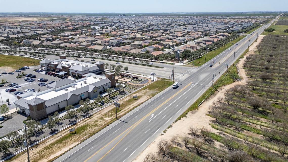 The Riverwalk shopping area at the Riverbend Ranch home development comes into view from Highway 12 in Madera County on Wednesday, April 9, 2025. Avenue 12 will be going under a major widening construction project between Highway 41 and Road 40.