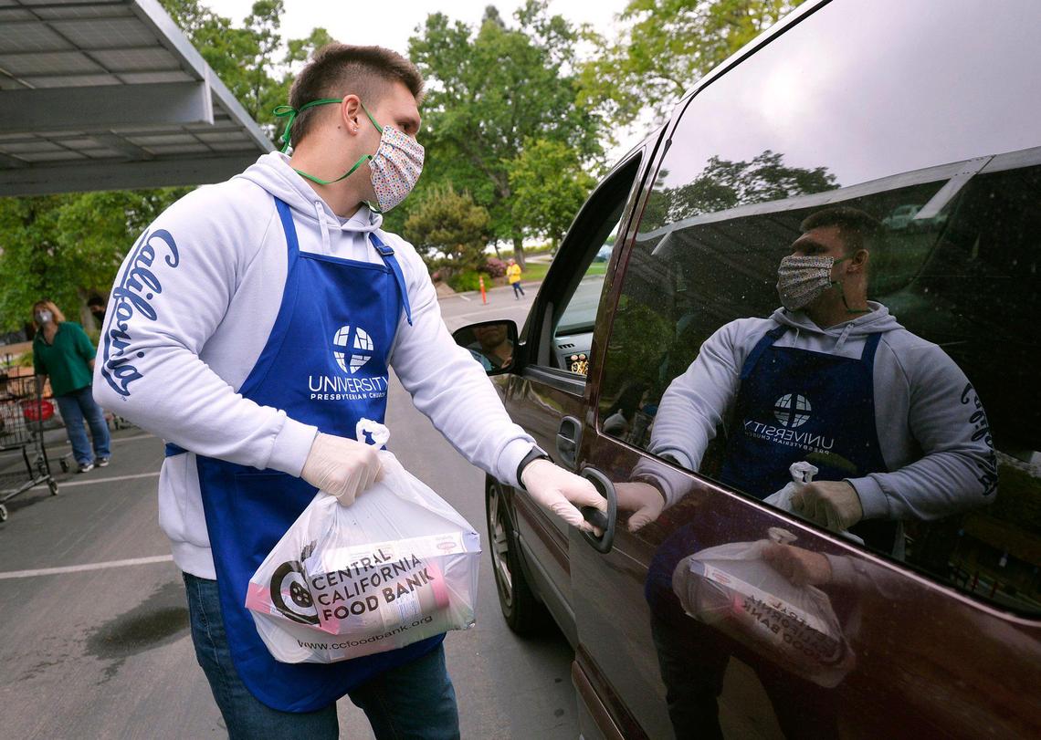 San Joaquin Memorial graduate and University of California, Berkeley’s Zach Angelillo helps distribute food at a giveaway held at University Presbyterian Church of Fresno Saturday morning, April 18, 2020 in Fresno.
