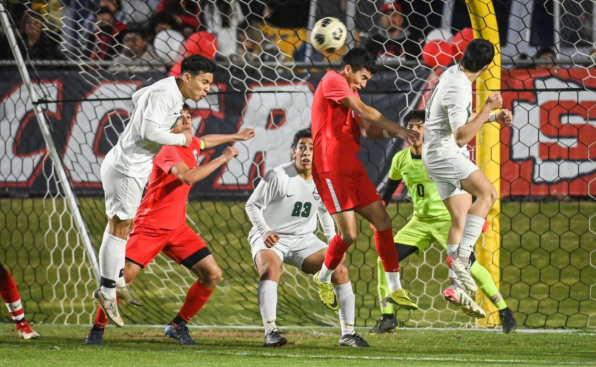 Sanger players defend a shot on their goal from Reedley during their Central Section Division I soccer championship game at Sanger’s Tom Flores Stadium on Friday, Feb. 25, 2022.
