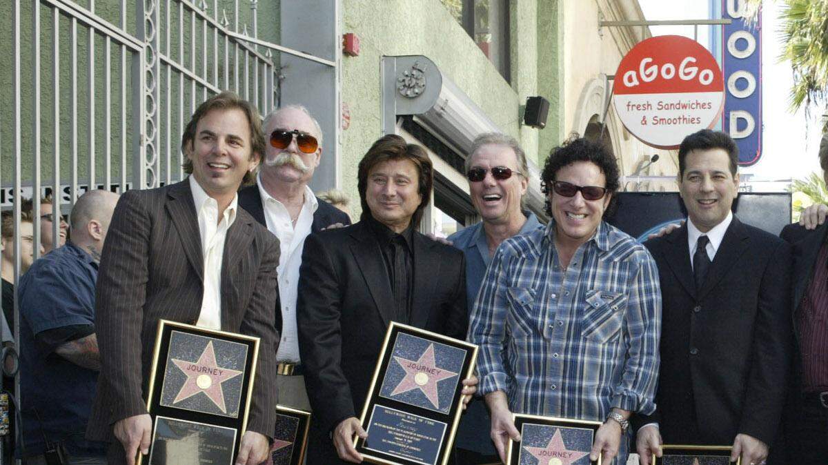 Open arms. A star on the Hollywood Walk of Fame is enough to bring any band together. From left: Jonathan Cain, George Tickner, former lead vocalist Steve Perry, Aynsley Dunbar, Neal Schon, Robert Fleischman, Ross Valory, Steve Augeri, Steve Smith and Deen Castronovo.
